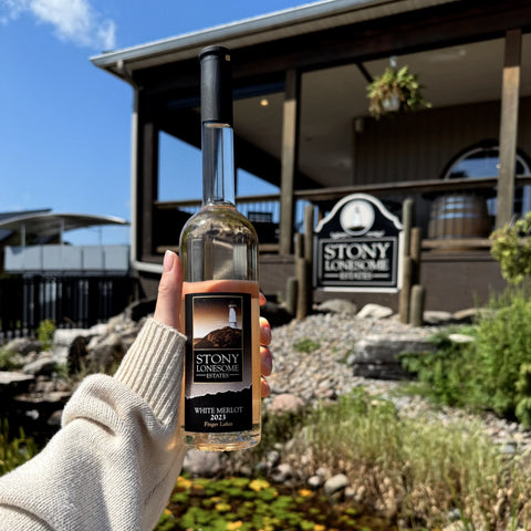 a bottle of White Merlot in front of the Stony Lonesome tasting room at Three Brothers Wineries in the Finger Lakes